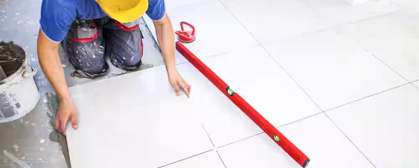 Large-format floor tile being installed and leveled
